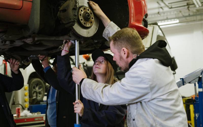 Student and tutor working on car in SWC automative workshop
